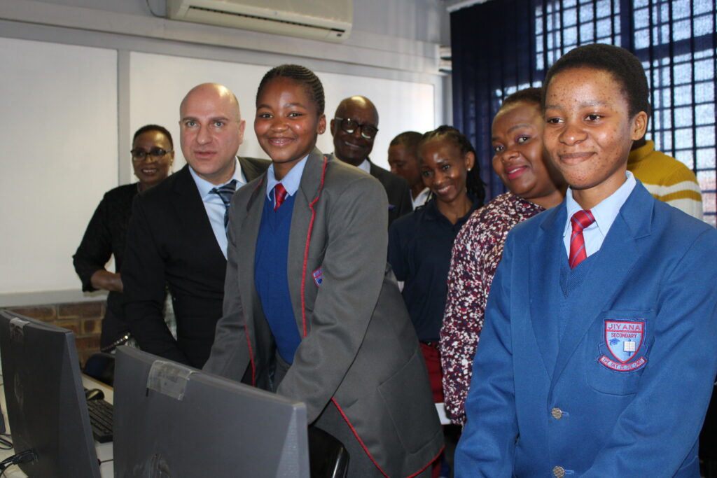 Stavros Nicolaou, far left with students who gratefully received Aspen's donation of computers and tablets.